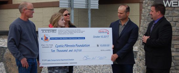 District 6 celebrates US-20 improvements with $10,000 for Cystic Fibrosis