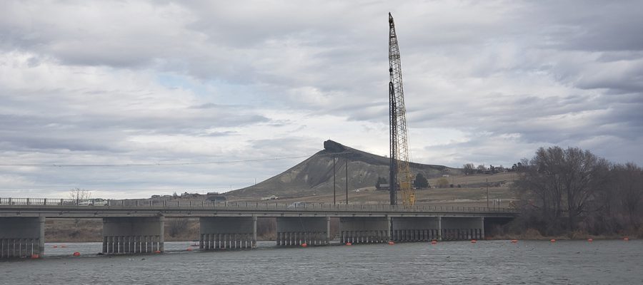 A crane looms over a bridge