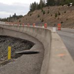 Barrels and guardrail separate traffic on US-95 from the Rock Creek slide.
