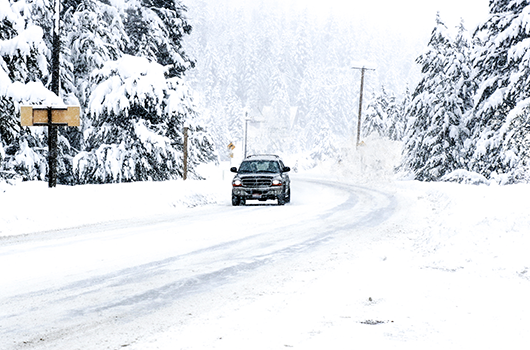 Single car traveling in winter weather.