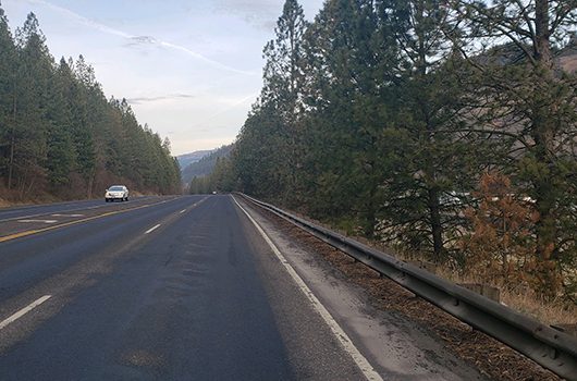 A car passes the Orofino Airport on US-12