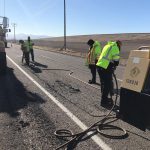 Four men on highway with jackhammers