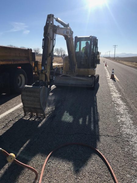 track hoe on highway