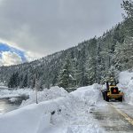 A loader makes a path through the avalanche