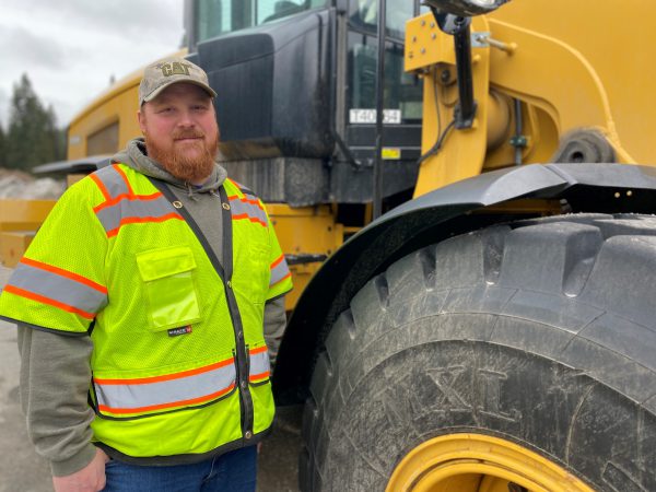 Henderson stands by a loader