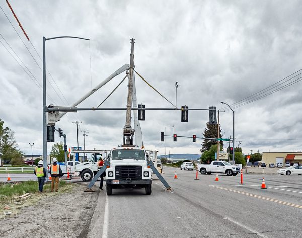 Workers and truck working on damaged light pole