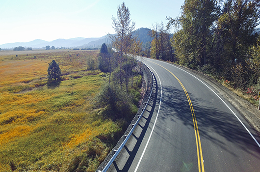Fall sunshine on a curve on a widened highway