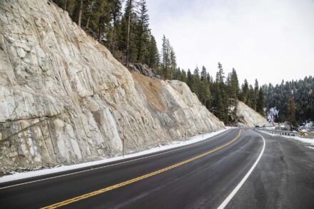 A road with a steep cliff on one side.