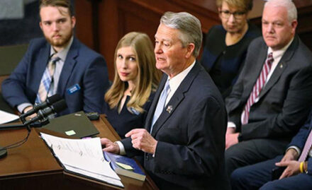 Governor Brad Little speaking in the Idaho Statehouse.