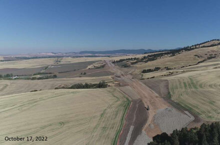 A drone shot of the new US-95 Thorn Creek to Moscow project cutting through rolling hills.