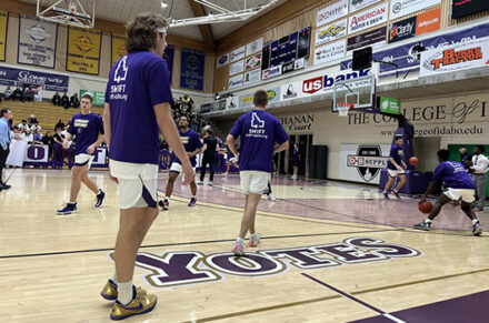 College of Idaho basketball players on the court.