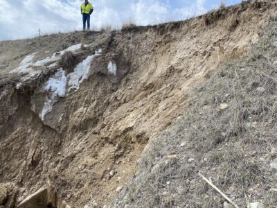 Landslide with man standing at top.