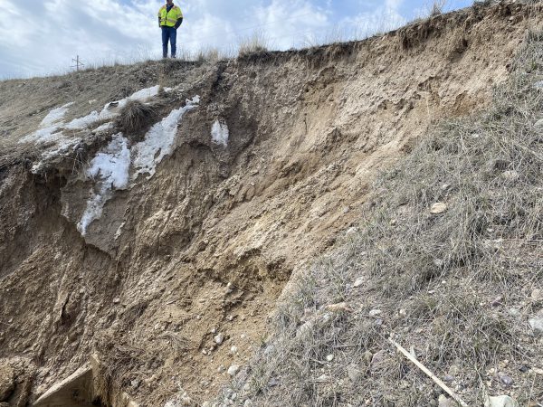 ITD Employee overlooks a washed-out hillside