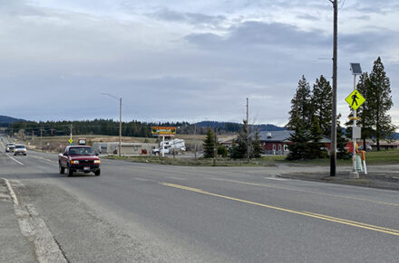 A red truck drivers through Plummer on US-95
