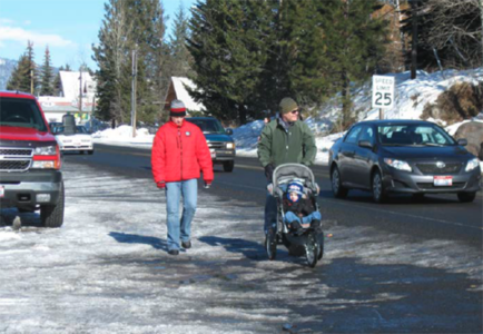 Pedestrians walking on the side of a road.