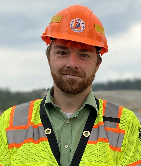 A man in a hard hat and safety vest.