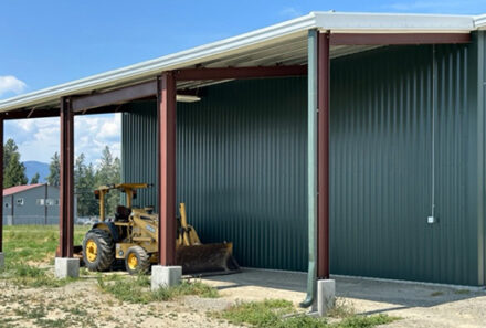 A tractor next to a building.