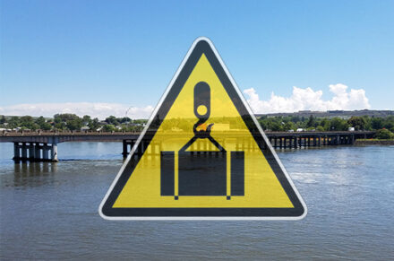 A logo of a crane over a picture of the U.S. Highway 12 Memorial Bridge in Lewiston.