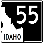 Graphic showing a State Highway 55 road sign with a white background and black outline. The sign reads “Idaho 55” with the state shape and shield design typical of Idaho highway markers.