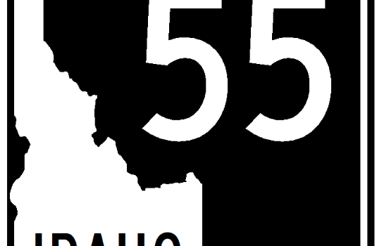 Graphic showing a State Highway 55 road sign with a white background and black outline. The sign reads “Idaho 55” with the state shape and shield design typical of Idaho highway markers.