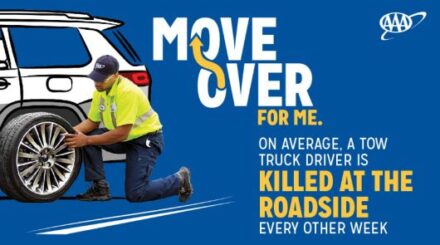 A graphic that says "Move over for me." Man is changing a tire on the side of the road.