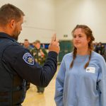 An officer practices a field sobriety test