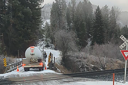 A propane truck on a bridge.