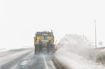 View from behind the plow of it pushing snow