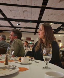 A woman at a banquet table.