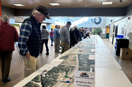 Open house guests look at exhibits