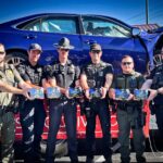 Police officers standing in a line showcasing their awards