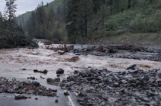 Picture of a rockslide and flooding on the highway.