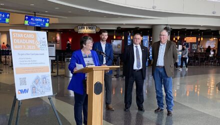 DMV Administrator, Lisa McClellan speaking at a podium in the rotunda at the Boise Airport.