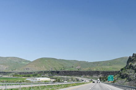 A highway with rolling hills in the background.