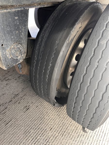 A damaged inside tire on a semitruck.