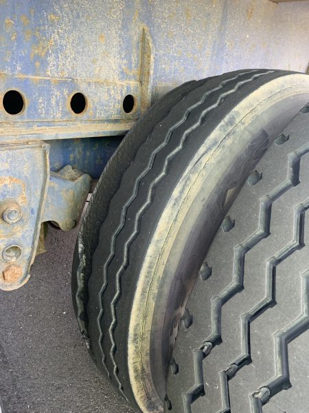A damaged inside tire on a semitruck.