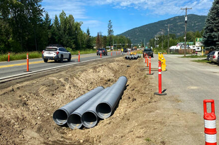 Pipes staged in a ditch in preparation for construction.