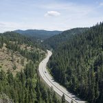 Drone shot of I-90 weaving through the mountains in North Idaho