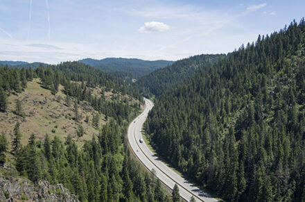 Drone shot of I-90 weaving through the mountains in North Idaho