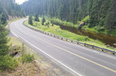 State Highway 14 next to a river and forest.