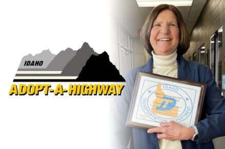 A woman poses with a plaque