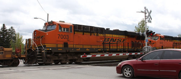 Vehicle waiting as a BNSF train safely passes through an intersection in North Idaho.