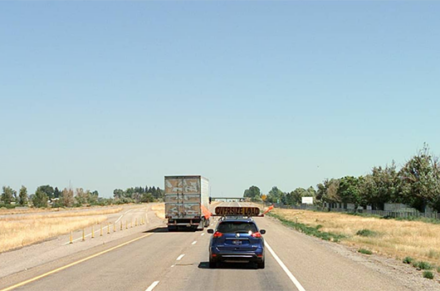 A semi and car travel on I-15