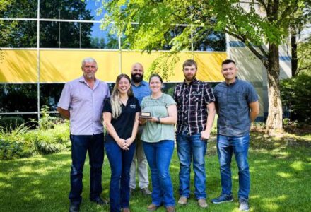 Group poses for award