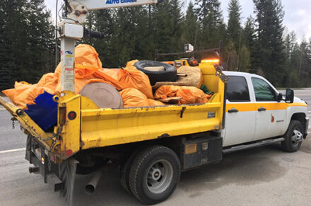 An ITD truck with orange trash bags.
