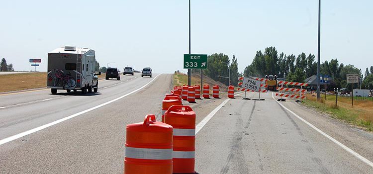 US-20 Exit 333 into Rexburg with construction markers and road closed barricades in place.