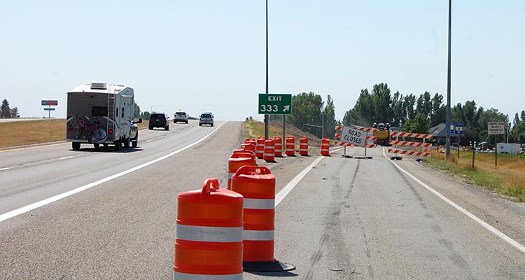 US-20 Exit 333 into Rexburg with construction markers and road closed barricades in place.