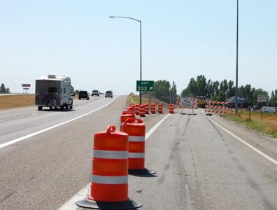 US-20 Exit 333 into Rexburg with construction markers and road closed barricades in place at the ramp