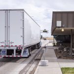 A semi truck next to the East Boise Port of Entry building.