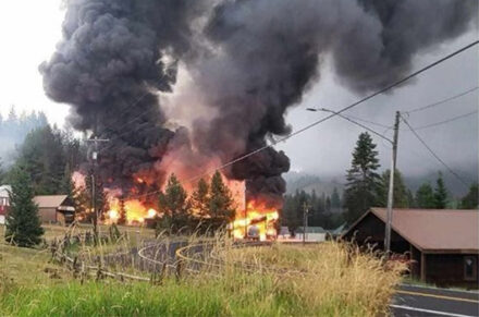 A large structure fire and plume of black smoke near SH-11 by the small city of Cardiff.